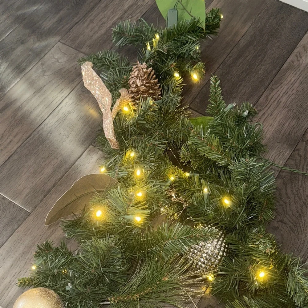 Festive Green Holiday Garland with Gold Accents and lights